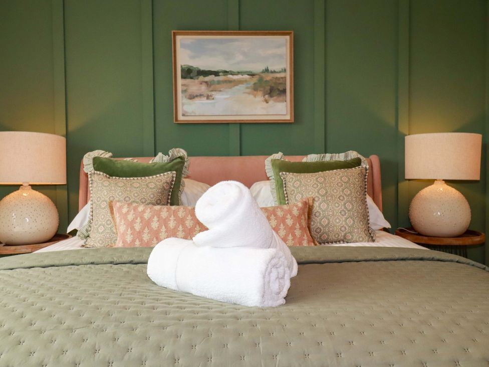 A bedroom with a bed and lamps at 8 Karn Havos in St. Eval near Mawgan Porth