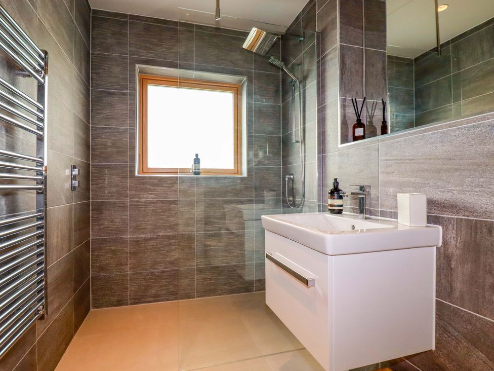 A bathroom with a shower and sink at 8 Karn Havos St. Eval near Mawgan Porth
