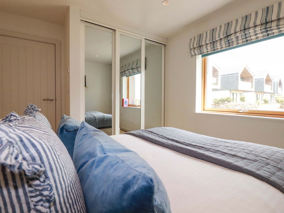 A bedroom with a bed and pillows at 8 Karn Havos St. Eval near Mawgan Porth