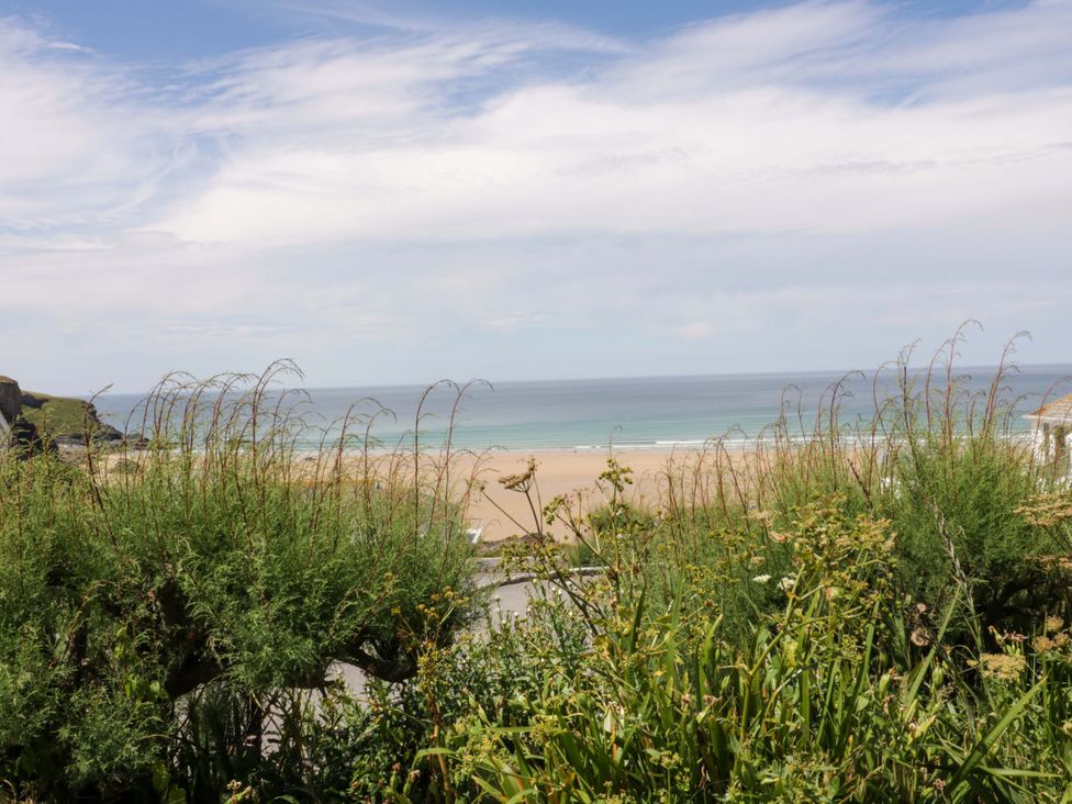 A view of the sea and sand from a grassy area at 8 Karn Havos St. Eval near Mawgan Porth