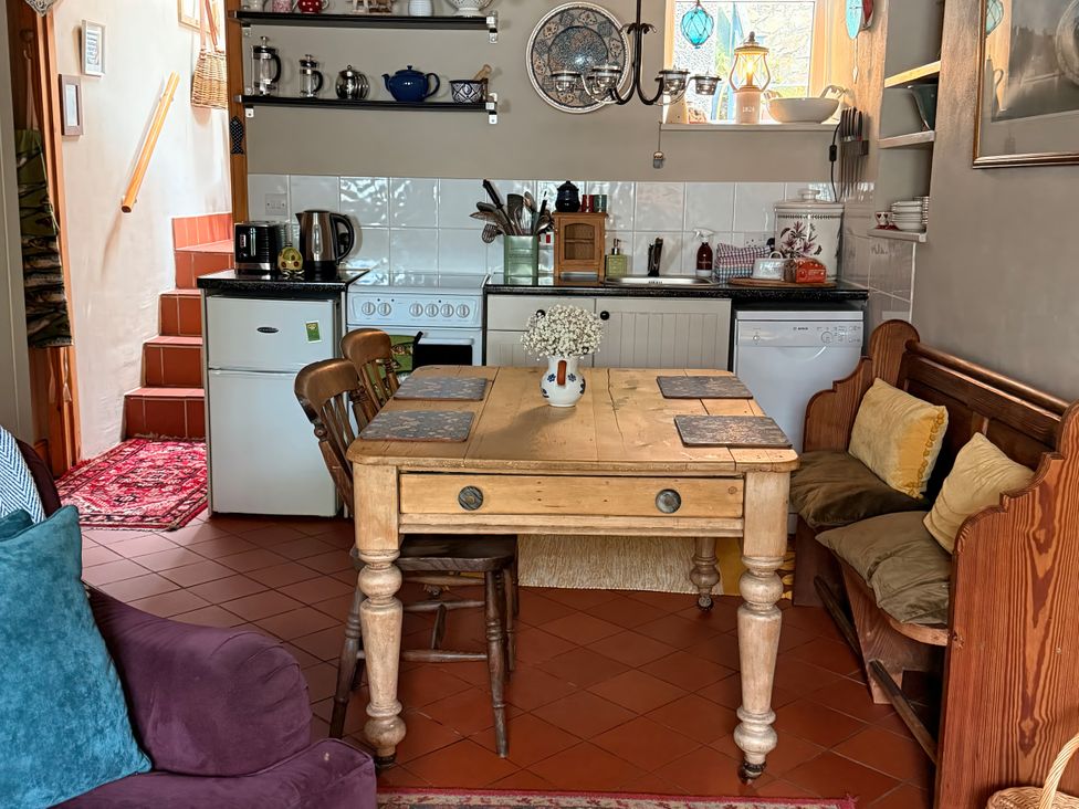 A kitchen with a table and chairs at Copper Miners Cottage, Beddgelert, Eryri (snowdonia)