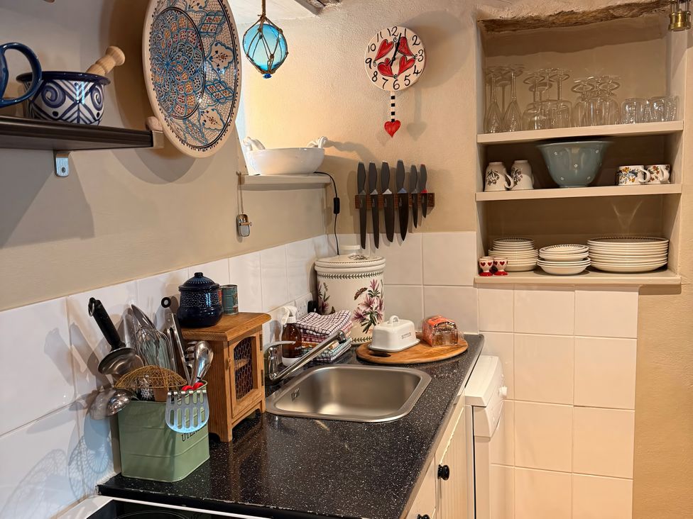 A kitchen with sink and utensils at Copper Miners Cottage, Beddgelert, Eryri (snowdonia)