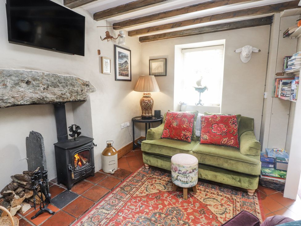 A living room with a sofa and fireplace at Copper Miners Cottage, Beddgelert, Eryri (snowdonia)