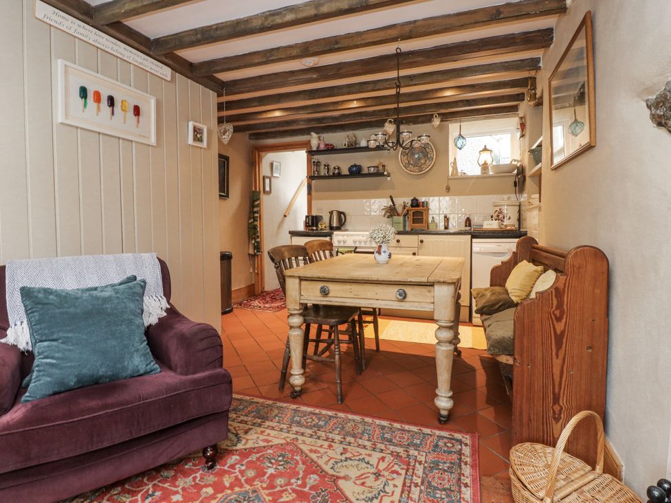 A kitchen with a dining table and chairs at Copper Miners Cottage, Beddgelert, Eryri (snowdonia)