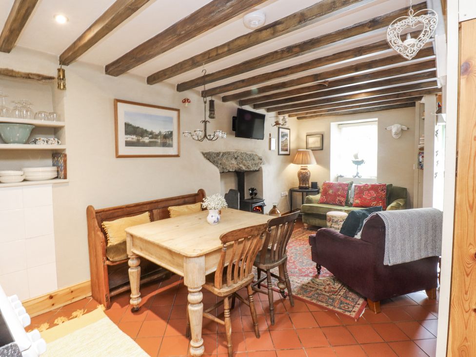 A living room with a table and chairs at Copper Miners Cottage Beddgelert, Eryri (snowdonia)