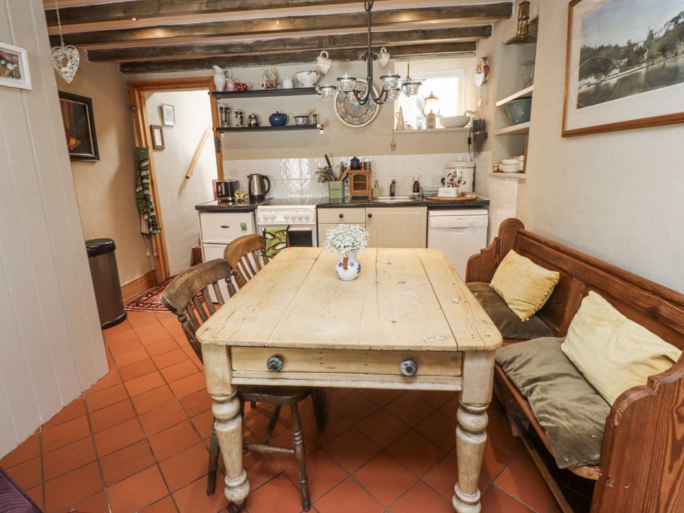 A kitchen with a table and chairs at Copper Miners Cottage, Beddgelert, Eryri (snowdonia)