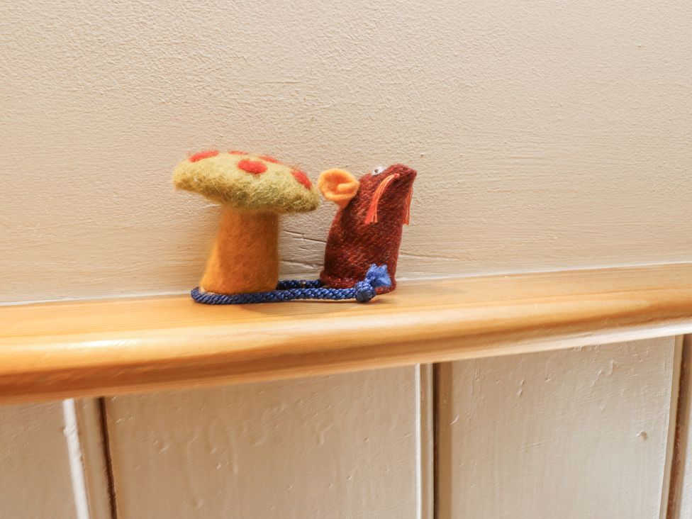 A felt mushroom and a felt mouse on a shelf at Copper Miners Cottage, Beddgelert, Eryri (snowdonia)