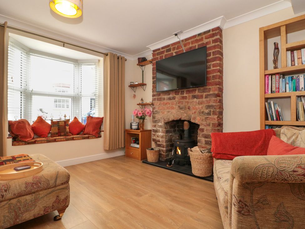 A living room with a fireplace and television at No.64 Nelson St, Bridlington