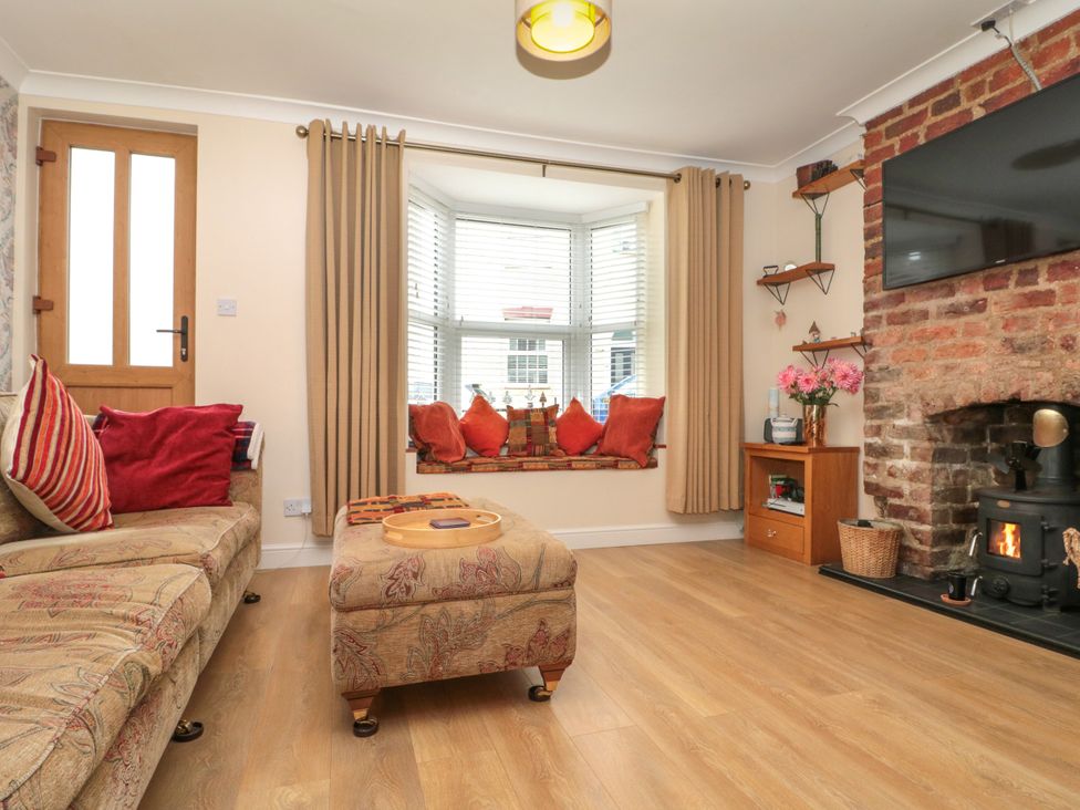 A living room with a couch and television at No.64 Nelson St Bridlington