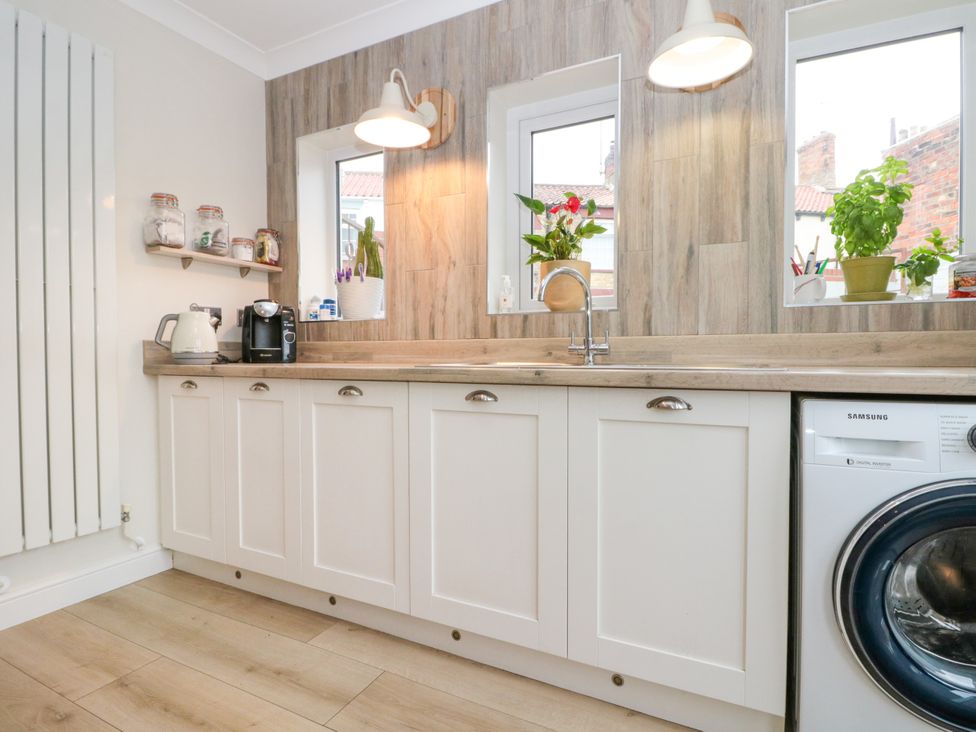 A kitchen with a sink and cabinets at No.64 Nelson St in Bridlington