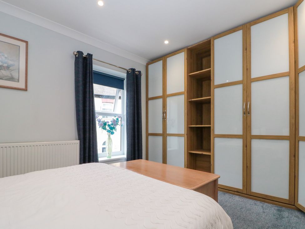 A bedroom with a bed and a wardrobe at No.64 Nelson St in Bridlington