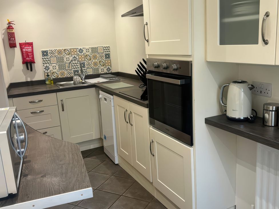 A kitchen with appliances and sink at Sun House in Allonby