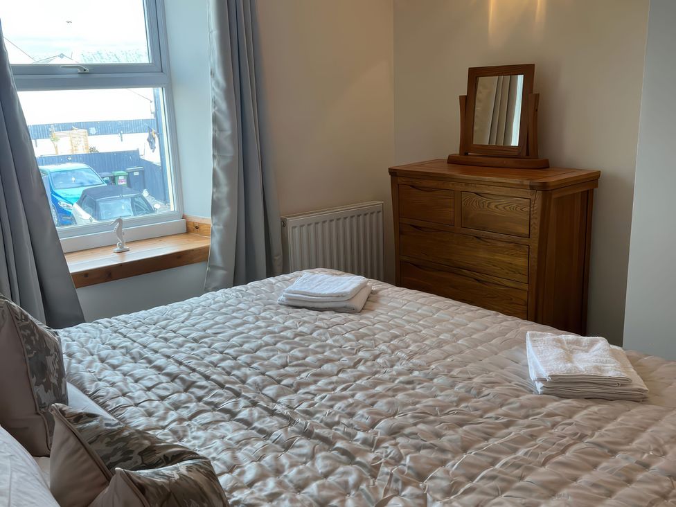 A bedroom with a bed and a dresser at Sun House in Allonby