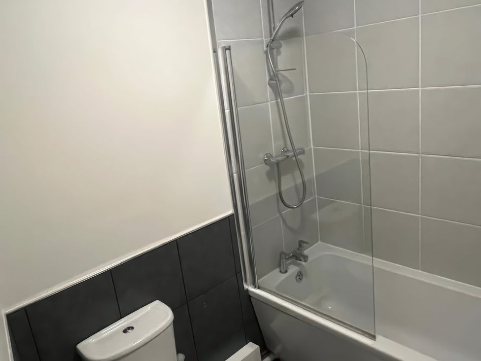 A bathroom with a bathtub and toilet at Sun House in Allonby