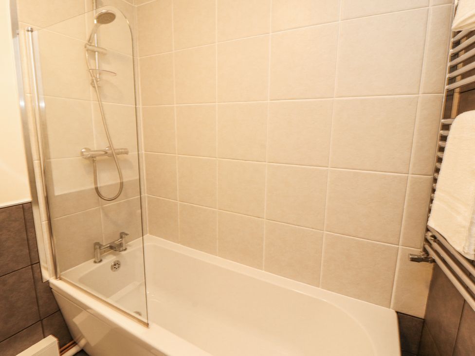 A bathroom with a bathtub and shower at Sun House in Allonby