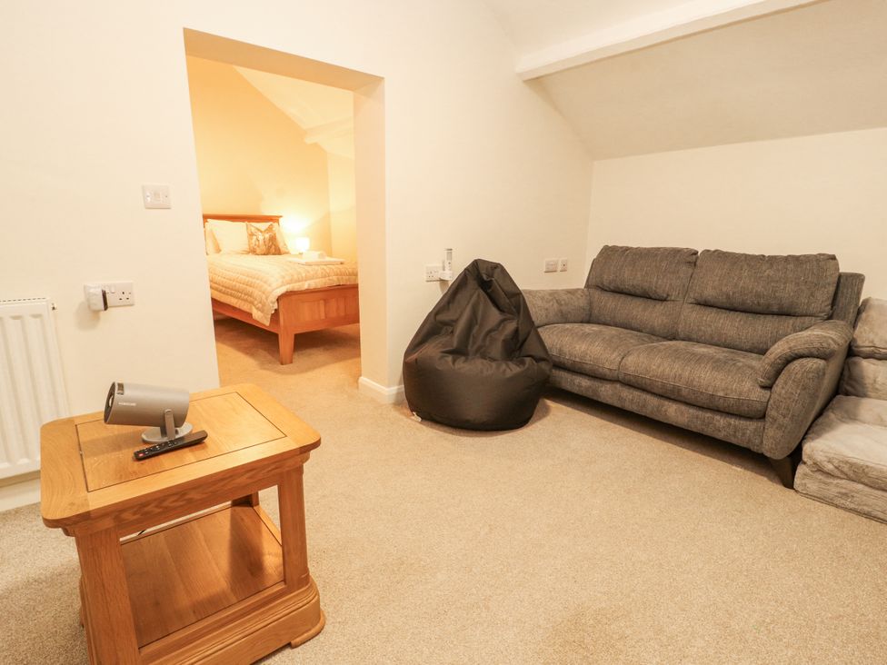 A living room with a sofa and coffee table at Sun House in Allonby