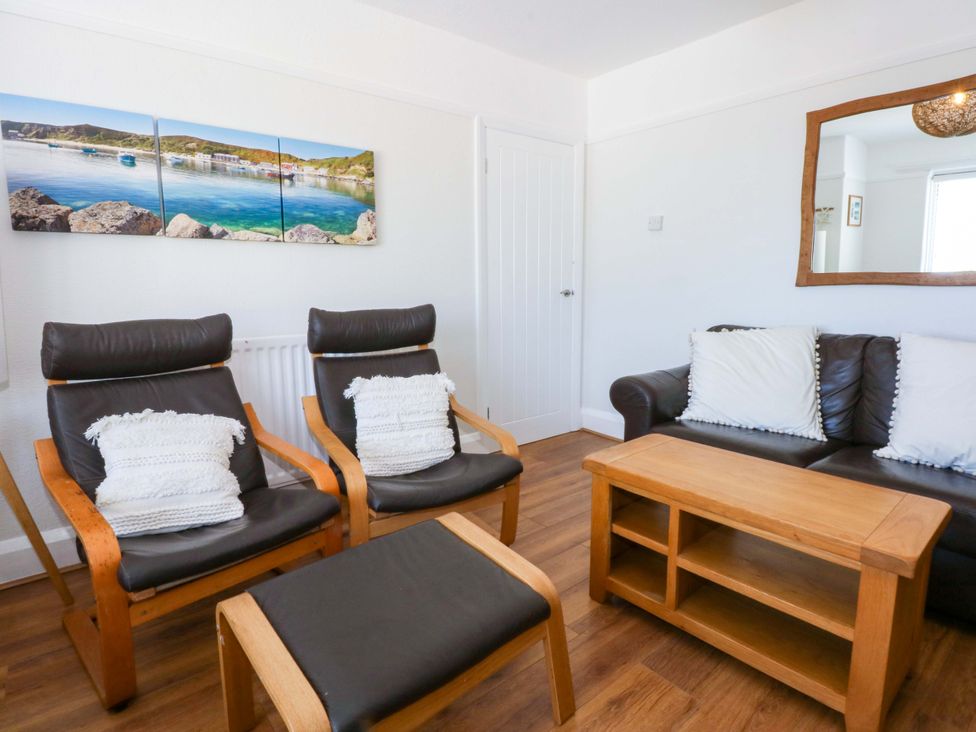 A living room with two armchairs and a coffee table at Swn Y Don