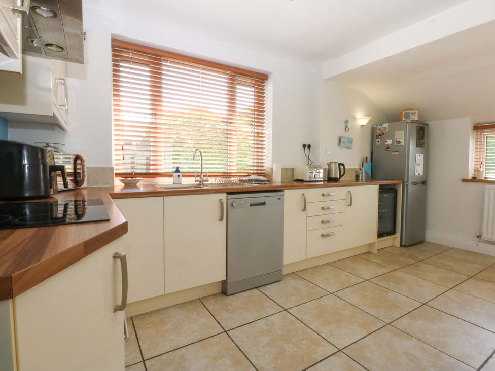 A kitchen with cabinets and appliances at Swn Y Don