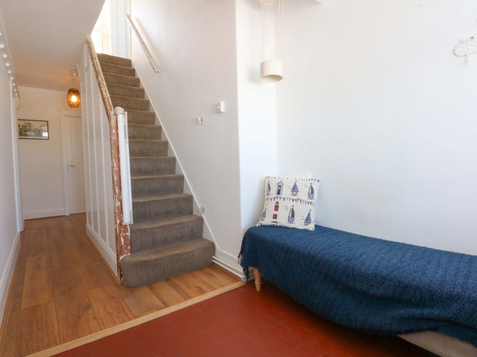 A hallway with stairs and a couch at Swn Y Don in 