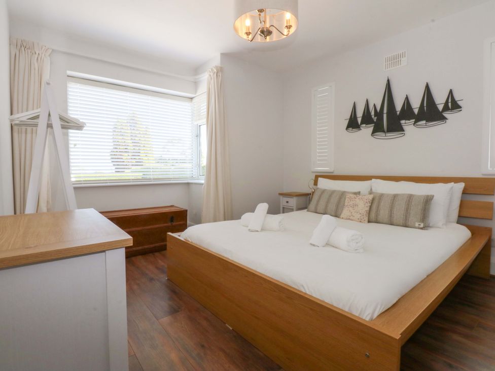 A bedroom with a bed and bedside table at Swn Y Don