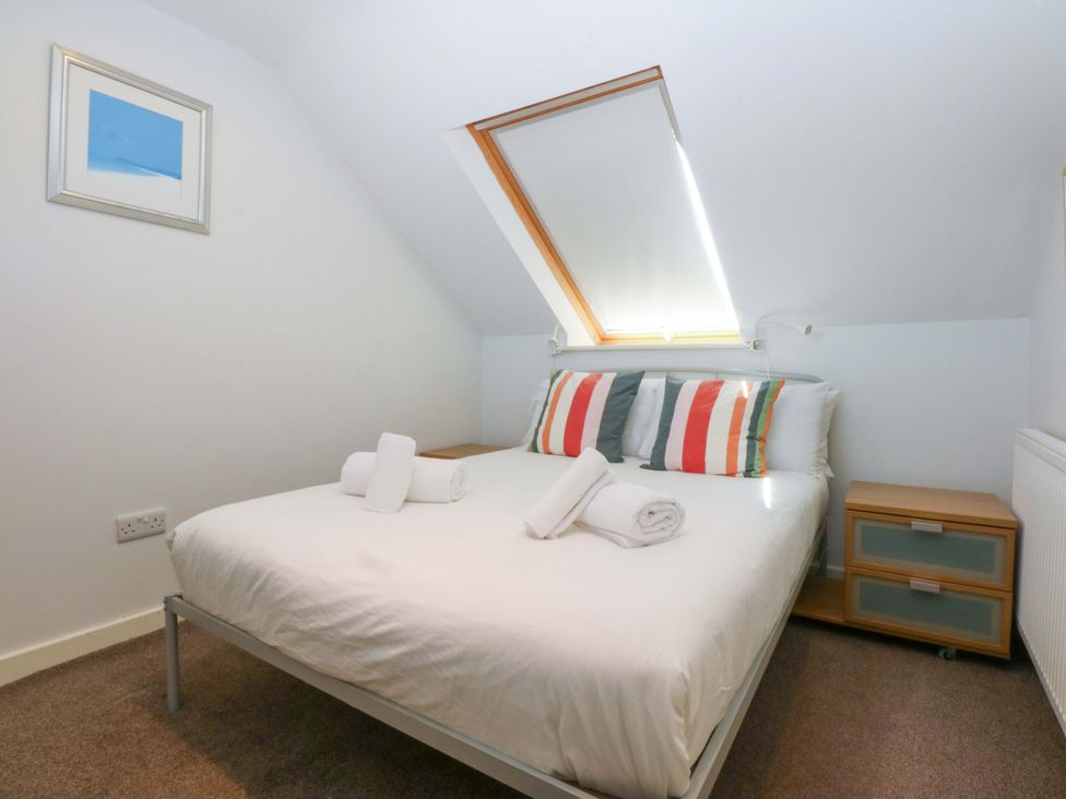 A bedroom with a bed and window at Swn Y Don 