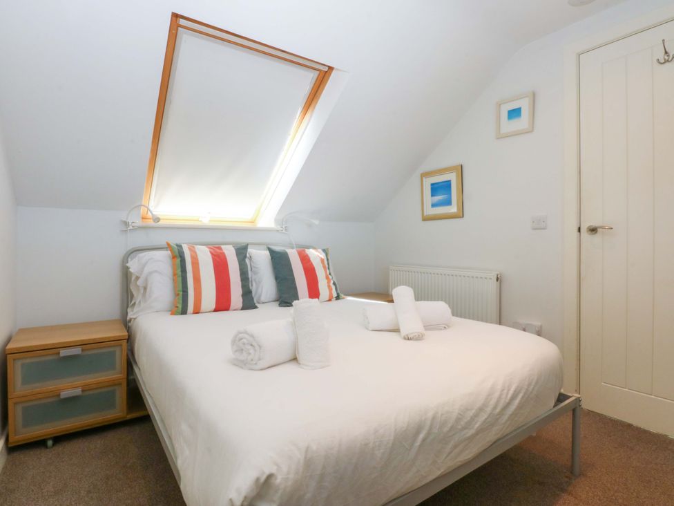 A bedroom with a bed and a nightstand at Swn Y Don