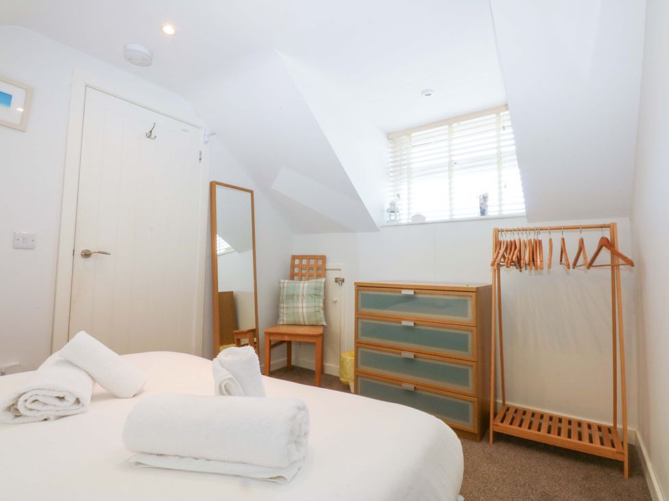 A bedroom with a bed and furniture at Swn Y Don