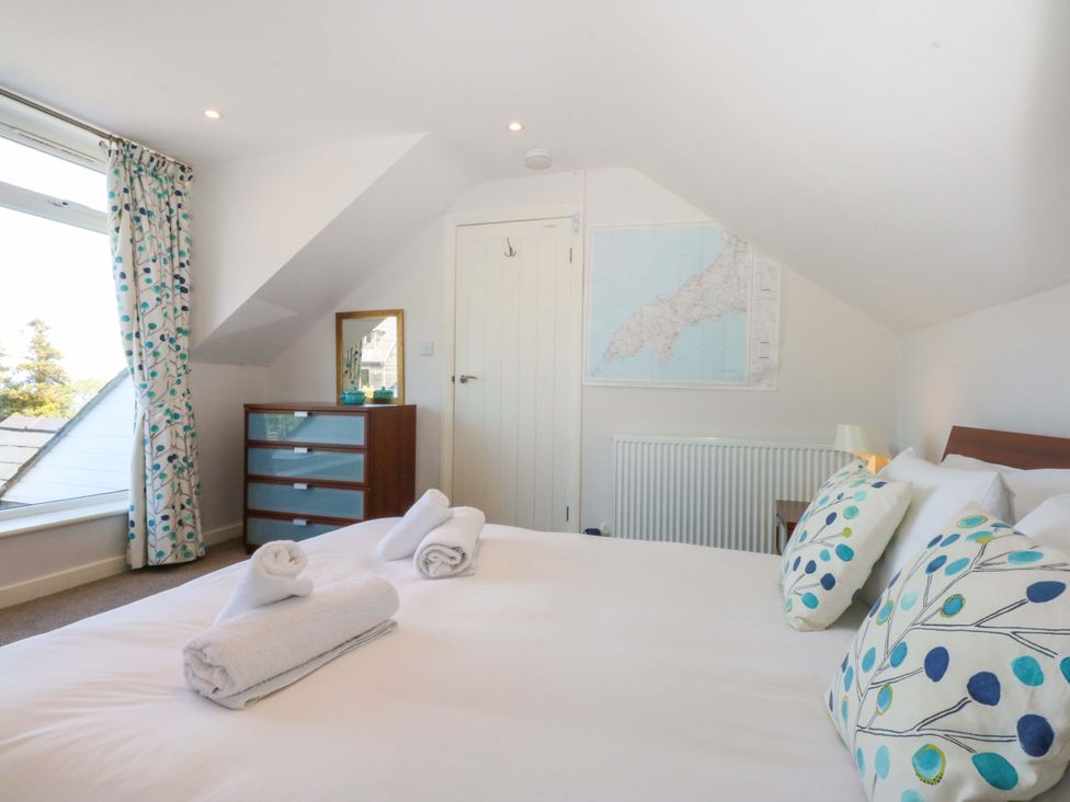 A bedroom with a bed and dresser at Swn Y Don