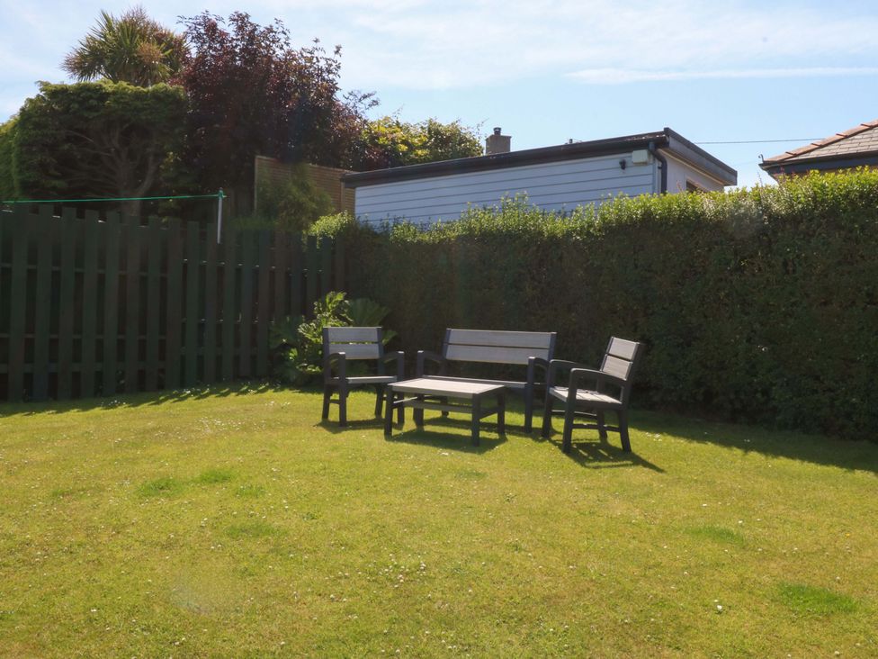 A garden with seating area and a shed at Swn Y Don