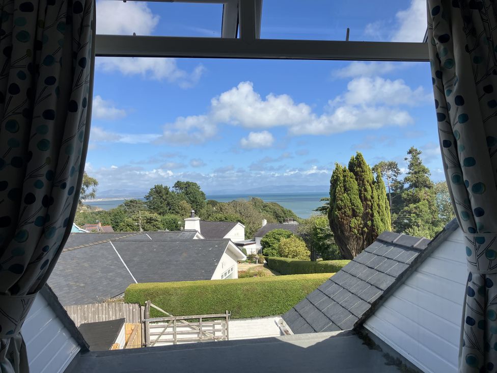 A view of the sea and houses from a window at Swn Y Don in Llanbedrog