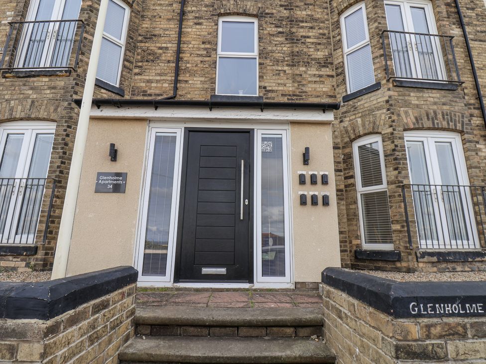 An entrance with a black door and mailboxes at Glenholme Apartments in Redcar