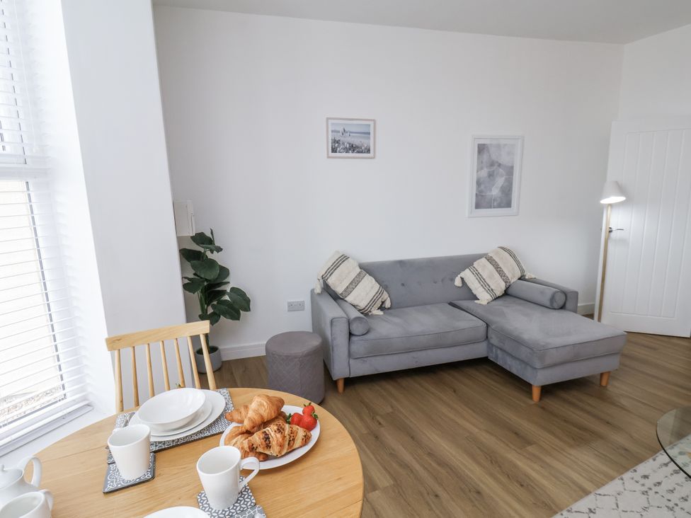 A living room with a sofa and dining table at Apartment 2 in Redcar