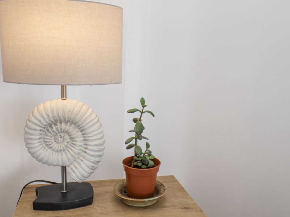A lamp and a plant on a table at Apartment 2 in Redcar