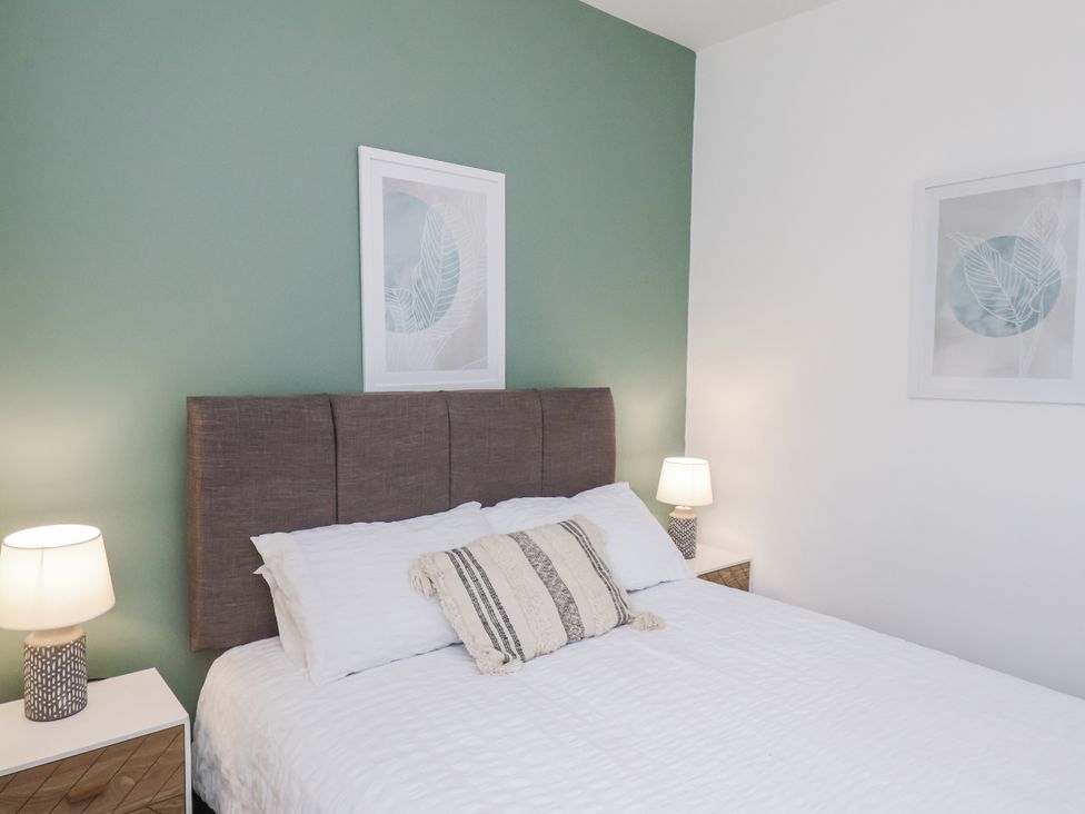 A bedroom with a bed and lamps at Apartment 2 in Redcar