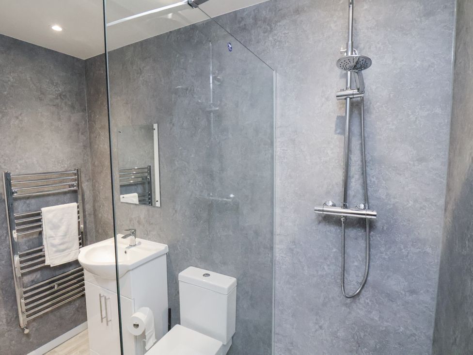 A bathroom with a shower, toilet, and sink at Apartment 2 Redcar