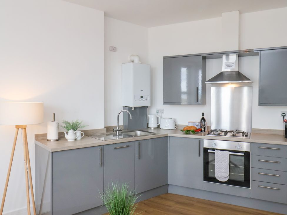 A kitchen with modern fixtures and a gas stove at Apartment 1 (2 bed) Redcar