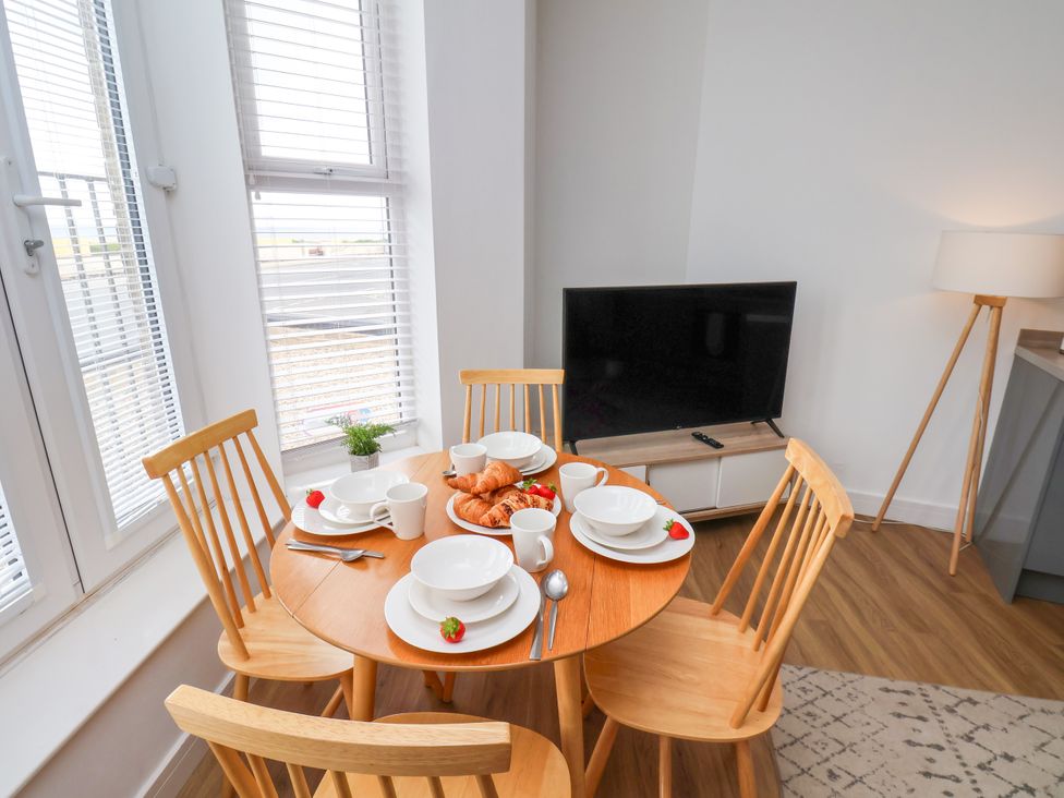 A dining room with a table set for breakfast at Apartment 1 ( 2 bed ) Redcar