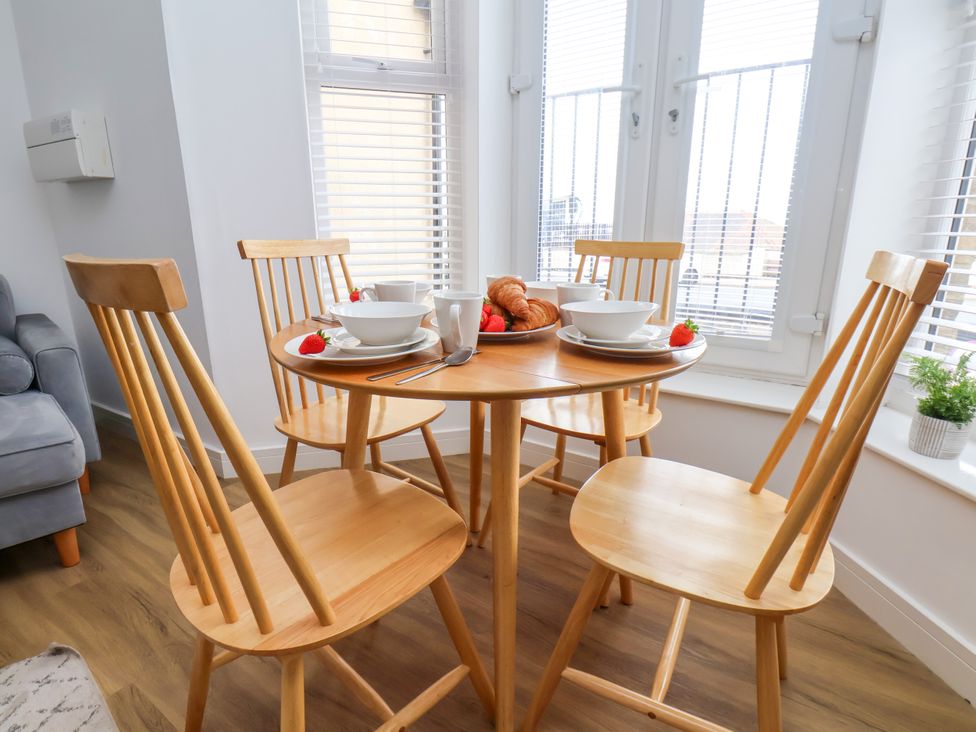 A dining room table set with bowls and food at Apartment 1 ( 2 bed ) Redcar