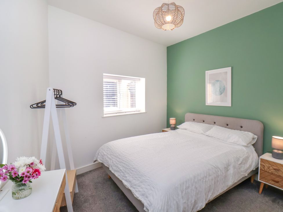A bedroom with a bed and window at Apartment 1 (2 bed) in Redcar