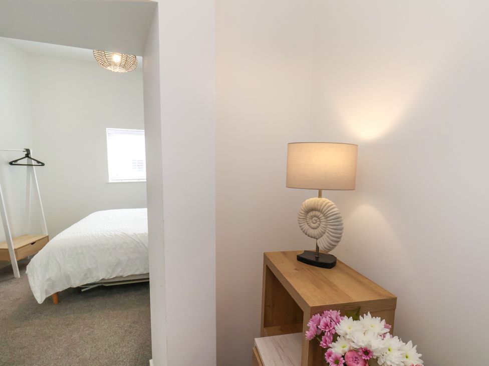 A bedroom with a bed and a lamp at Apartment 1 ( 2 bed ) in Redcar
