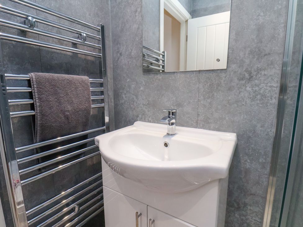 A bathroom with a sink and towel rack at Apartment 1 (2 bed) Redcar