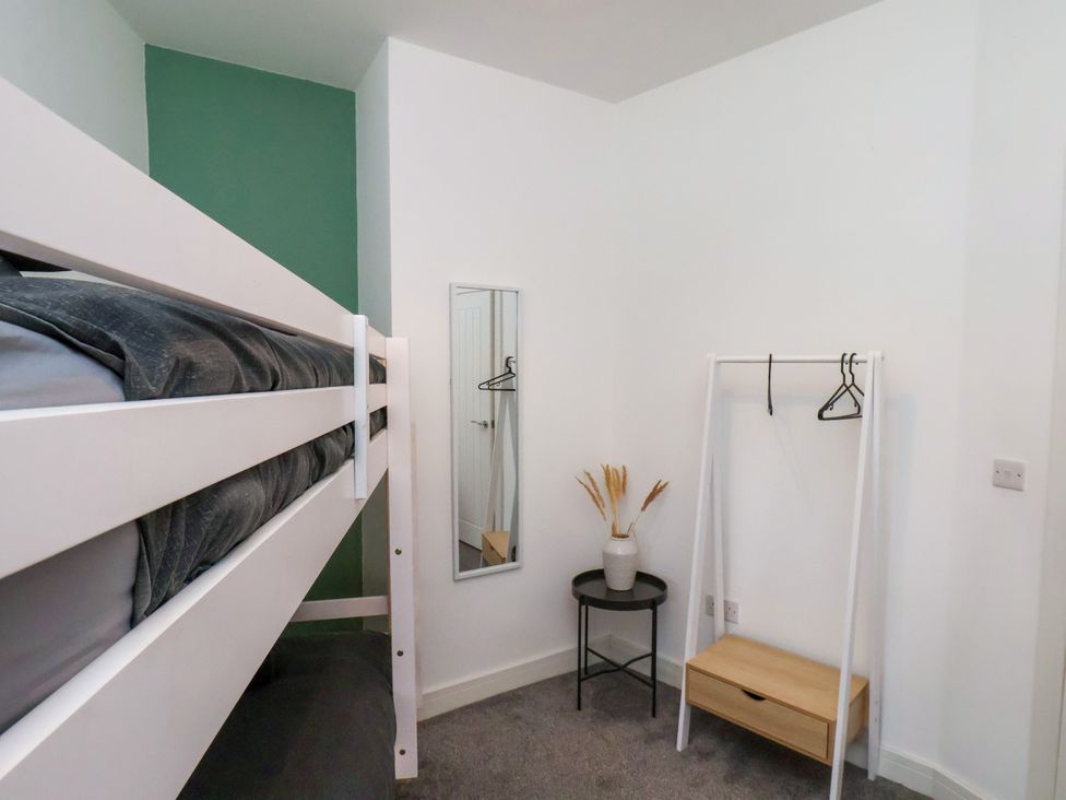 A bedroom with a bunk bed and a mirror at Apartment 1 (2 bed) Redcar