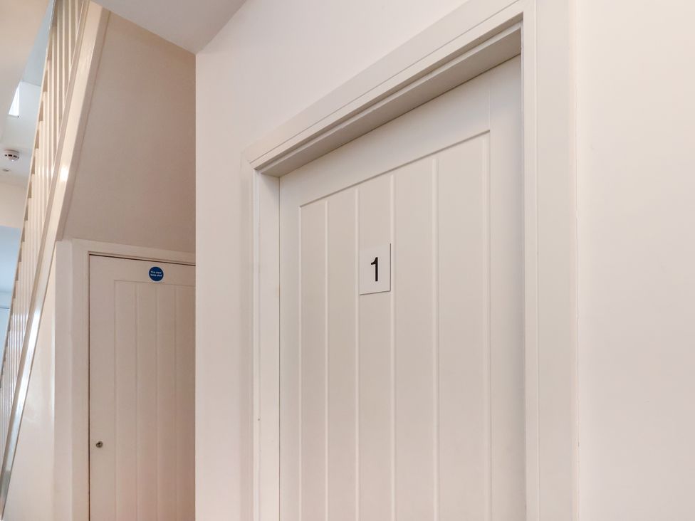 A hallway with two doors and stairs at Apartment 1 (2 bed) in Redcar