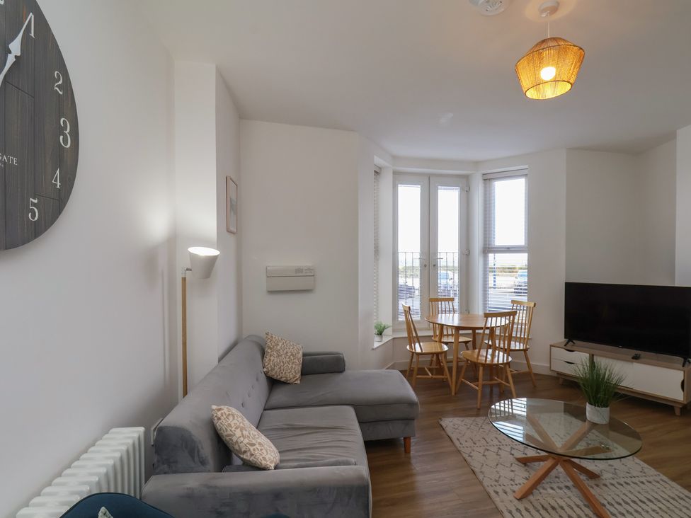 A living room with a sofa and dining table at Glenholme Apartment 1 in Redcar