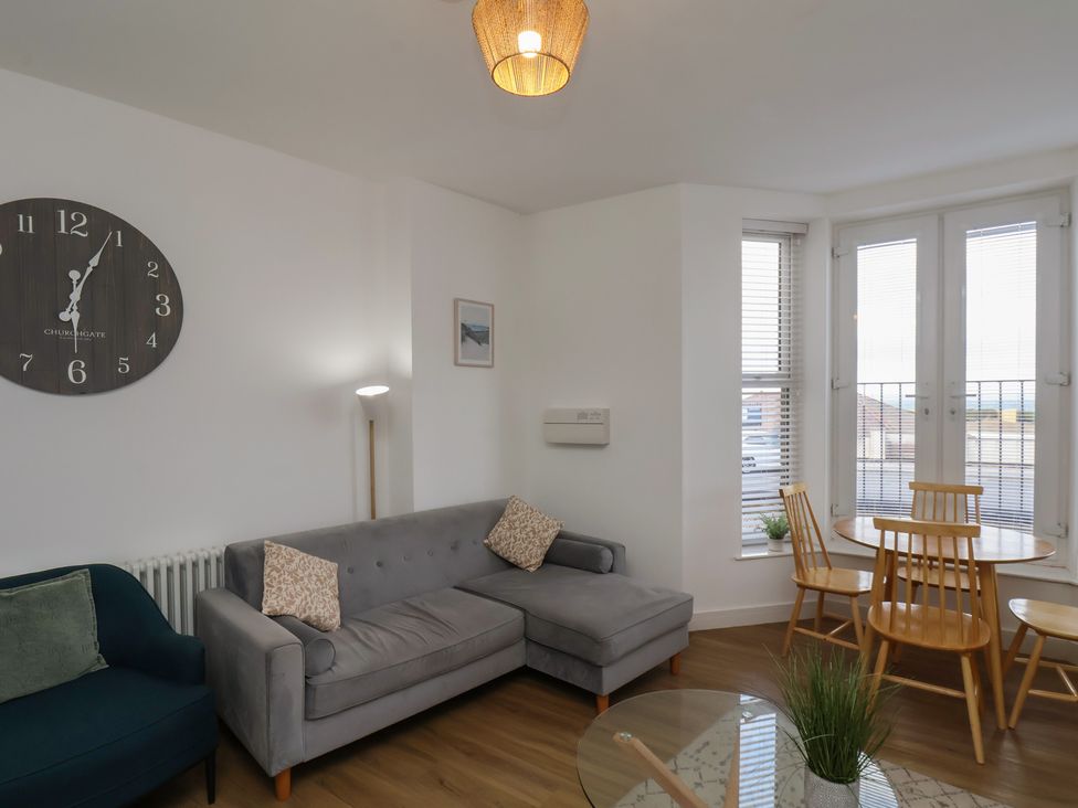 A living room with a sofa and dining table at Glenholme Apartment 1 in Redcar