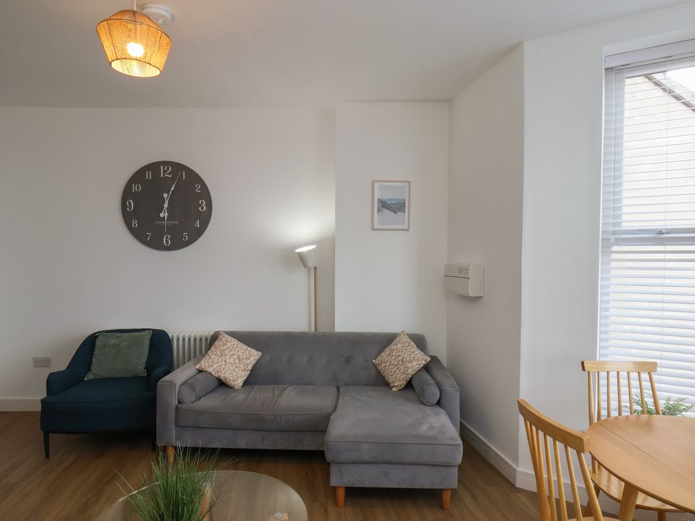 A living room with a sofa and dining table at Glenholme Apartment 1 in Redcar