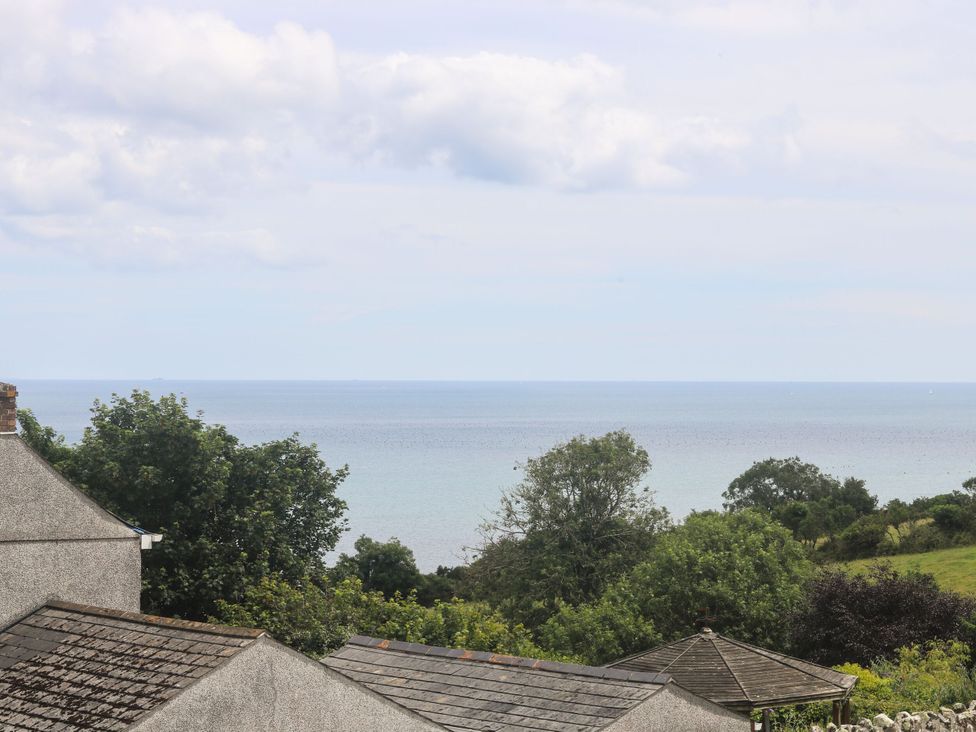 View of the sea and trees at Driftwood Cottage in St. Austell