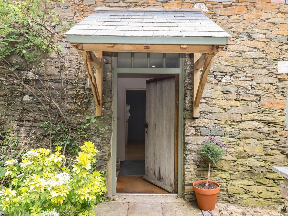 An entrance with a door and plants at Lower Velwell Barn in Totnes