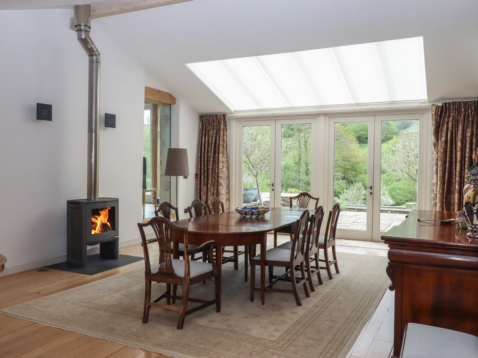 A dining room with a table and chairs at Lower Velwell Barn Totnes