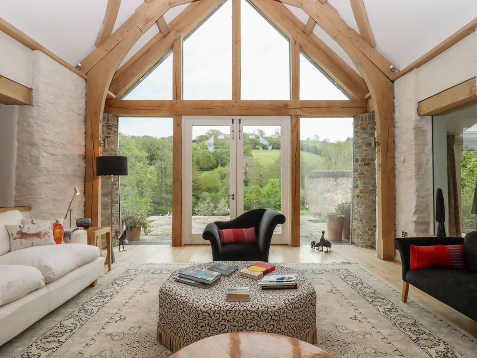 A living room with sofa and coffee table at Lower Velwell Barn in Totnes